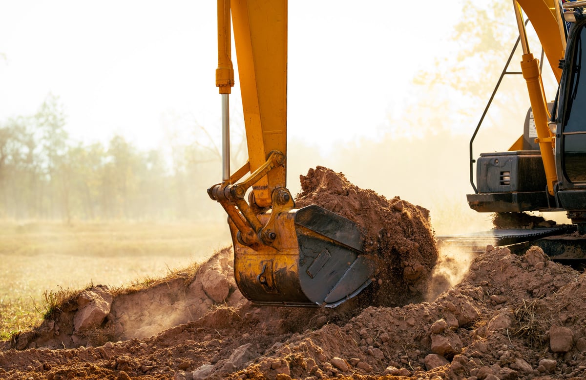 Heavy equipment moving soil on site